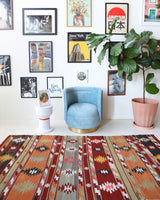 Vintage kilim rug in living room setting, old rug, antique rug, pastel colors, faded colors, Turkish rug, vintage rug, soft rug, Portland, Oregon, rug store, rug shop, local shop, earthy tones, earthy colors, warm colors