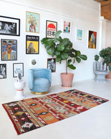 Vintage kilim rug in living room setting, old rug, antique rug, pastel colors, faded colors, Turkish rug, vintage rug, soft rug, Portland, Oregon, rug store, rug shop, local shop, earthy tones, earthy colors, warm colors