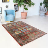 Vintage Turkish rug in a living room setting, pile rug, Turkish rug, vintage rug, portland, rug shop, bright colors, wild shaman, soft rug, bold color, Portland, Oregon, rug store, rug shop, local shop, antique rug