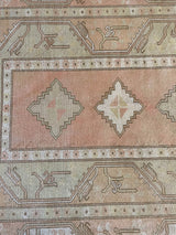 Vintage Turkish rug in living room setting, old rug, antique rug, pastel colors, faded colors, Turkish rug, vintage rug, soft rug, Portland, Oregon, rug store, rug shop, local shop