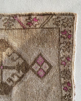 Vintage Turkish mini rug in room decor setting, old rug, antique rug, pastel colors, faded colors, Turkish rug, vintage rug, soft rug, Portland, Oregon, rug store, rug shop, local shop