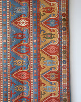 Vintage Turkish rug in a living room setting, pile rug, Turkish rug, vintage rug, portland, rug shop, bright colors, wild shaman, soft rug, bold color, Portland, Oregon, rug store, rug shop, local shop, antique rug,