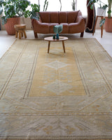 Area rug in a living room setting, pile rug, Turkish rug, old rug, antique rug, pastel colors, faded colors, Turkish rug, vintage rug, soft rug, Portland, Oregon, rug store, rug shop, local shop, warm colors
