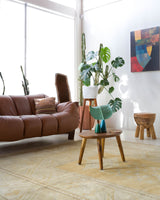 Area rug in a living room setting, pile rug, Turkish rug, old rug, antique rug, pastel colors, faded colors, Turkish rug, vintage rug, soft rug, Portland, Oregon, rug store, rug shop, local shop, warm colors