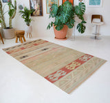 Vintage kilim rug in living room setting, old rug, antique rug, pastel colors, faded colors, Turkish rug, vintage rug, soft rug, Portland, Oregon, rug store, rug shop, local shop, earthy tones, earthy colors, warm colors, flat weave