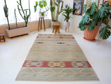 Vintage kilim rug in living room setting, old rug, antique rug, pastel colors, faded colors, Turkish rug, vintage rug, soft rug, Portland, Oregon, rug store, rug shop, local shop, earthy tones, earthy colors, warm colors, flat weave
