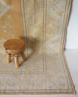 Area rug in a living room setting, pile rug, Turkish rug, old rug, antique rug, pastel colors, faded colors, Turkish rug, vintage rug, soft rug, Portland, Oregon, rug store, rug shop, local shop, warm colors