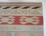 Vintage kilim rug in living room setting, old rug, antique rug, pastel colors, faded colors, Turkish rug, vintage rug, soft rug, Portland, Oregon, rug store, rug shop, local shop, earthy tones, earthy colors, warm colors, flat weave