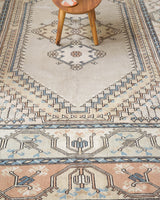 Area rug in a living room setting, pile rug, Turkish rug, old rug, antique rug, pastel colors, faded colors, Turkish rug, vintage rug, soft rug, Portland, Oregon, rug store, rug shop, local shop, pastel colors, warm colors
