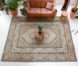 Area rug in a living room setting, pile rug, Turkish rug, old rug, antique rug, pastel colors, faded colors, Turkish rug, vintage rug, soft rug, Portland, Oregon, rug store, rug shop, local shop, pastel colors, warm colors