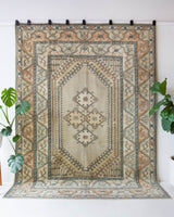 Area rug in a living room setting, pile rug, Turkish rug, old rug, antique rug, pastel colors, faded colors, Turkish rug, vintage rug, soft rug, Portland, Oregon, rug store, rug shop, local shop, pastel colors, warm colors