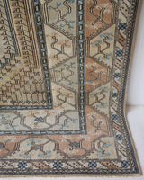 Area rug in a living room setting, pile rug, Turkish rug, old rug, antique rug, pastel colors, faded colors, Turkish rug, vintage rug, soft rug, Portland, Oregon, rug store, rug shop, local shop, pastel colors, warm colors