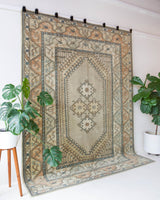 Area rug in a living room setting, pile rug, Turkish rug, old rug, antique rug, pastel colors, faded colors, Turkish rug, vintage rug, soft rug, Portland, Oregon, rug store, rug shop, local shop, pastel colors, warm colors