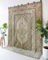 Area rug in a living room setting, pile rug, Turkish rug, old rug, antique rug, pastel colors, faded colors, Turkish rug, vintage rug, soft rug, Portland, Oregon, rug store, rug shop, local shop, pastel colors, warm colors