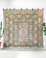 Area rug in a living room setting, pile rug, Turkish rug, old rug, antique rug, pastel colors, faded colors, Turkish rug, vintage rug, soft rug, Portland, Oregon, rug store, rug shop, local shop, pastel colors, warm colors