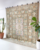 Area rug in a living room setting, pile rug, Turkish rug, old rug, antique rug, pastel colors, faded colors, Turkish rug, vintage rug, soft rug, Portland, Oregon, rug store, rug shop, local shop, pastel colors, warm colors