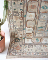 Area rug in a living room setting, pile rug, Turkish rug, old rug, antique rug, pastel colors, faded colors, Turkish rug, vintage rug, soft rug, Portland, Oregon, rug store, rug shop, local shop, pastel colors, warm colors