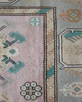 Area rug in a living room setting, pile rug, Turkish rug, old rug, antique rug, pastel colors, faded colors, Turkish rug, vintage rug, soft rug, Portland, Oregon, rug store, rug shop, local shop, pastel colors, warm colors