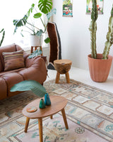 Area rug in a living room setting, pile rug, Turkish rug, old rug, antique rug, pastel colors, faded colors, Turkish rug, vintage rug, soft rug, Portland, Oregon, rug store, rug shop, local shop, pastel colors, warm colors