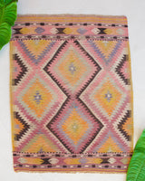 Vintage Turkish mini rug in room decor setting, old rug, antique rug, pastel colors, faded colors, Turkish rug, vintage rug, soft rug, Portland, Oregon, rug store, rug shop, local shop,  bright colors, bold colors