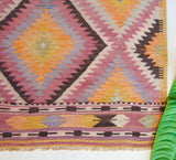 Vintage Turkish mini rug in room decor setting, old rug, antique rug, pastel colors, faded colors, Turkish rug, vintage rug, soft rug, Portland, Oregon, rug store, rug shop, local shop,  bright colors, bold colors