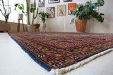 Vintage Turkish rug in a living room setting, pile rug, Turkish rug, vintage rug, portland, rug shop, bright colors, wild shaman, soft rug, bold color, Portland, Oregon, rug store, rug shop, local shop, antique rug