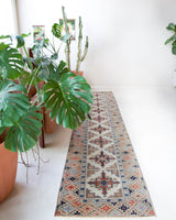 Vintage Turkish runner rug in living room setting, old rug, antique rug, pastel colors, faded colors, Turkish rug, vintage rug, soft rug, Portland, Oregon, rug store, rug shop, local shop
