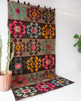 Vintage kilim rug in room decor setting, old rug, antique rug, pastel colors, faded colors, Turkish rug, vintage rug, soft rug, Portland, Oregon, rug store, rug shop, local shop, bold colors, bright colors, faded colors