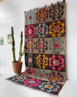 Vintage kilim rug in room decor setting, old rug, antique rug, pastel colors, faded colors, Turkish rug, vintage rug, soft rug, Portland, Oregon, rug store, rug shop, local shop, bold colors, bright colors, faded colors