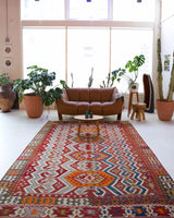 Vintage kilim rug in room decor setting, old rug, antique rug, pastel colors, faded colors, Turkish rug, vintage rug, soft rug, Portland, Oregon, rug store, rug shop, local shop, bold colors, bright colors, faded colors, antique kilim