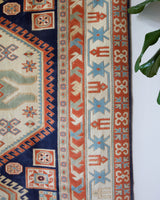 Vintage Turkish rug in a living room setting, pile rug, Turkish rug, vintage rug, portland, rug shop, bright colors, wild shaman, soft rug, bold color, Portland, Oregon, rug store, rug shop, local shop