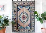 Vintage Turkish rug in living room setting, old rug, antique rug, pastel colors, faded colors, Turkish rug, vintage rug, soft rug, Portland, Oregon, rug store, rug shop, local shop