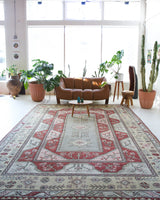 Vintage Turkish rug in living room setting, old rug, antique rug, pastel colors, faded colors, Turkish rug, vintage rug, soft rug, Portland, Oregon, rug store, rug shop, local shop