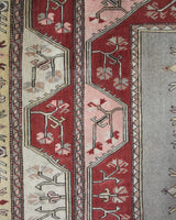 Vintage Turkish rug in living room setting, old rug, antique rug, pastel colors, faded colors, Turkish rug, vintage rug, soft rug, Portland, Oregon, rug store, rug shop, local shop