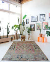 Vintage kilim rug in living room setting, old rug, antique rug, pastel colors, faded colors, Turkish rug, vintage rug, soft rug, Portland, Oregon, rug store, rug shop, local shop, earthy tones, earthy colors, warm colors