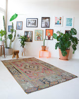 Vintage kilim rug in living room setting, old rug, antique rug, pastel colors, faded colors, Turkish rug, vintage rug, soft rug, Portland, Oregon, rug store, rug shop, local shop, earthy tones, earthy colors, warm colors