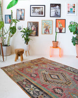 Vintage kilim rug in living room setting, old rug, antique rug, pastel colors, faded colors, Turkish rug, vintage rug, soft rug, Portland, Oregon, rug store, rug shop, local shop, earthy tones, earthy colors, warm colors