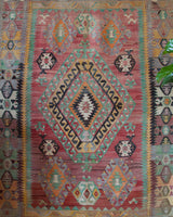 Vintage kilim rug in living room setting, old rug, antique rug, pastel colors, faded colors, Turkish rug, vintage rug, soft rug, Portland, Oregon, rug store, rug shop, local shop, earthy tones, earthy colors, warm colors
