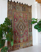 Vintage kilim rug in living room setting, old rug, antique rug, pastel colors, faded colors, Turkish rug, vintage rug, soft rug, Portland, Oregon, rug store, rug shop, local shop, earthy tones, earthy colors, warm colors