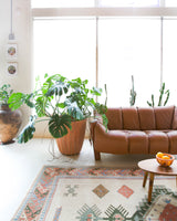 Vintage Turkish rug in living room setting, old rug, antique rug, pastel colors, faded colors, Turkish rug, vintage rug, soft rug, Portland, Oregon, rug store, rug shop, local shop