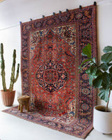 Antique Persian area rug in a living room setting, pile rug, vintage rug, portland, rug shop, bright colors, wild shaman, soft rug, bold color, Portland, Oregon, rug store, rug shop, local shop, antique rug, Persian rug, handmade rug, wool rug