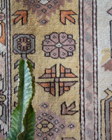 Vintage Turkish rug in living room setting, old rug, antique rug, pastel colors, faded colors, Turkish rug, vintage rug, soft rug, Portland, Oregon, rug store, rug shop, local shop
