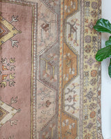 Vintage Turkish rug in living room setting, old rug, antique rug, pastel colors, faded colors, Turkish rug, vintage rug, soft rug, Portland, Oregon, rug store, rug shop, local shop