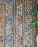 Vintage Turkish rug in living room setting, old rug, antique rug, pastel colors, faded colors, Turkish rug, vintage rug, soft rug, Portland, Oregon, rug store, rug shop, local shop