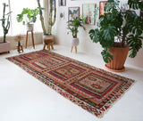 Vintage kilim rug in living room setting, old rug, antique rug, pastel colors, faded colors, Turkish rug, vintage rug, soft rug, Portland, Oregon, rug store, rug shop, local shop, earthy tones, earthy colors, warm colors