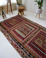 Vintage kilim rug in living room setting, old rug, antique rug, pastel colors, faded colors, Turkish rug, vintage rug, soft rug, Portland, Oregon, rug store, rug shop, local shop, earthy tones, earthy colors, warm colors