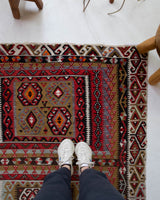 Vintage kilim rug in living room setting, old rug, antique rug, pastel colors, faded colors, Turkish rug, vintage rug, soft rug, Portland, Oregon, rug store, rug shop, local shop, earthy tones, earthy colors, warm colors