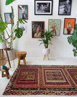 Vintage kilim rug in living room setting, old rug, antique rug, pastel colors, faded colors, Turkish rug, vintage rug, soft rug, Portland, Oregon, rug store, rug shop, local shop, earthy tones, earthy colors, warm colors