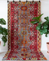 Vintage kilim rug in room decor setting, old rug, antique rug, pastel colors, faded colors, Turkish rug, vintage rug, soft rug, Portland, Oregon, rug store, rug shop, local shop, bold colors, bright colors, faded colors