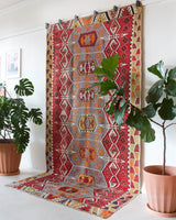 Vintage kilim rug in room decor setting, old rug, antique rug, pastel colors, faded colors, Turkish rug, vintage rug, soft rug, Portland, Oregon, rug store, rug shop, local shop, bold colors, bright colors, faded colors